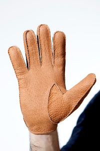 Palm of hand wearing Cork Unlined Peccary Unlined gloves for men by Ines
